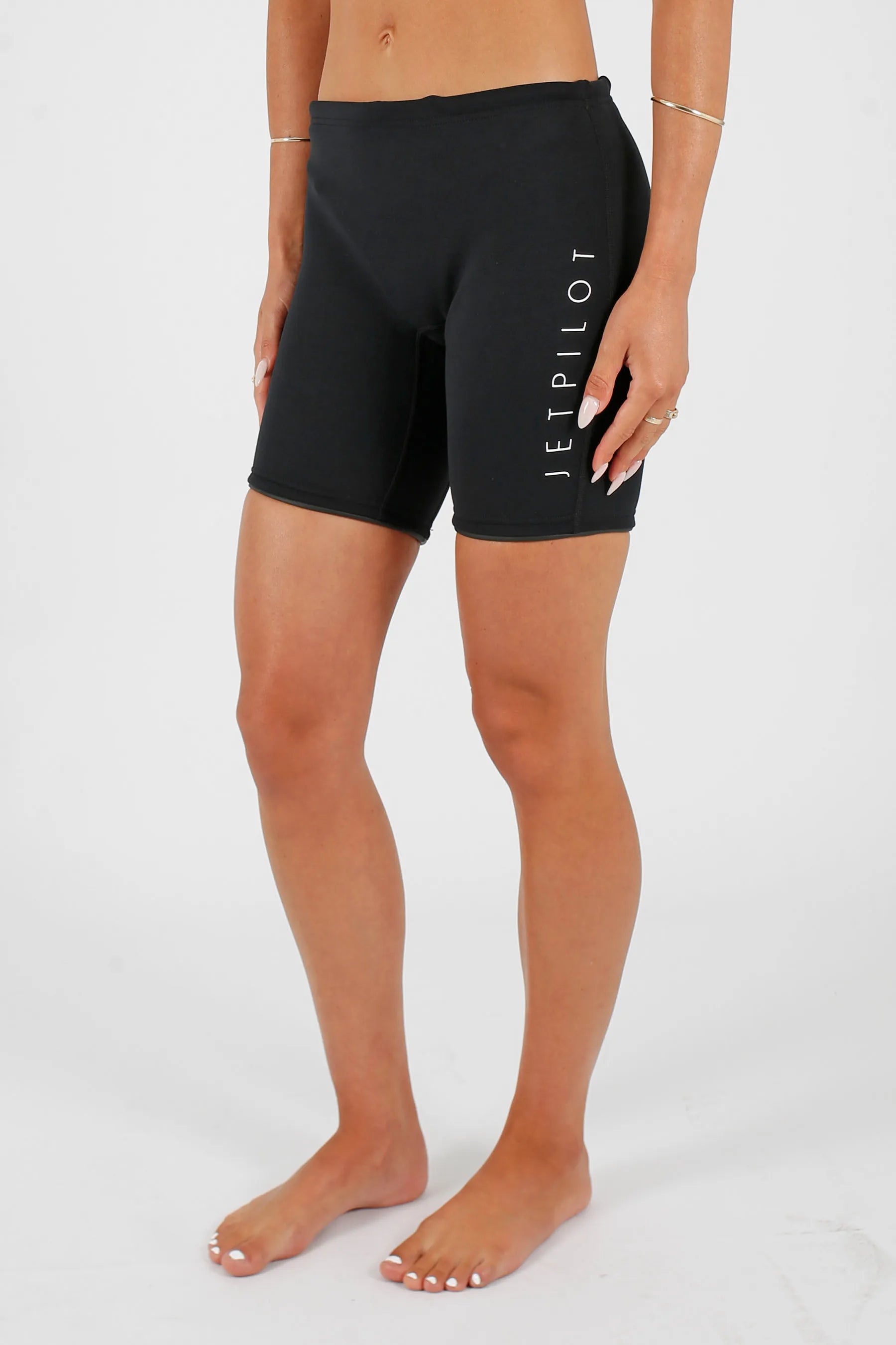 Person wearing Jetpilot Corp 7" Neoprene Short - Black with a brand logo on a white background