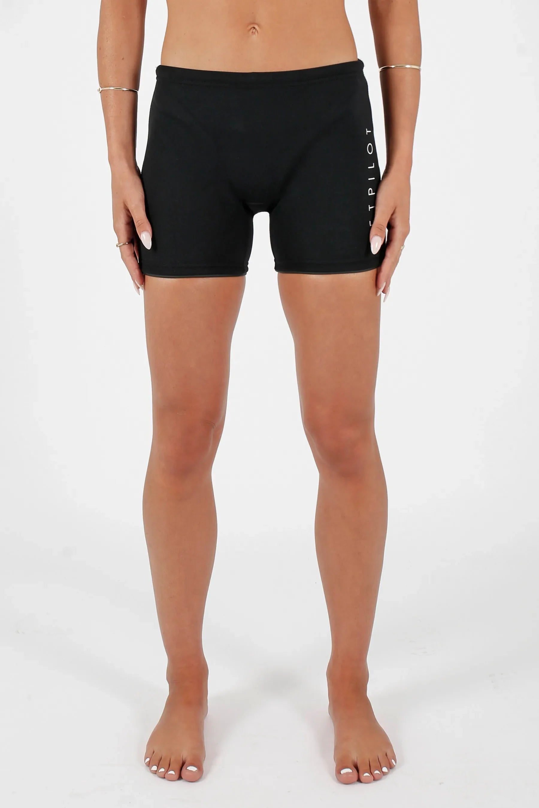 Woman in Jetpilot Corp 5" Neoprene Short - Black with a brand logo on a white background