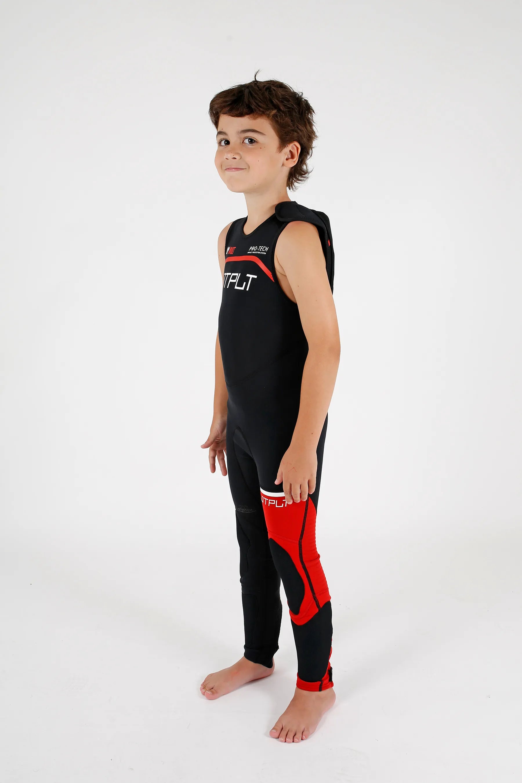 Child wearing a Jetpilot Vault Youth Race John - Black/Red youth wetsuit with visible branding on a white background