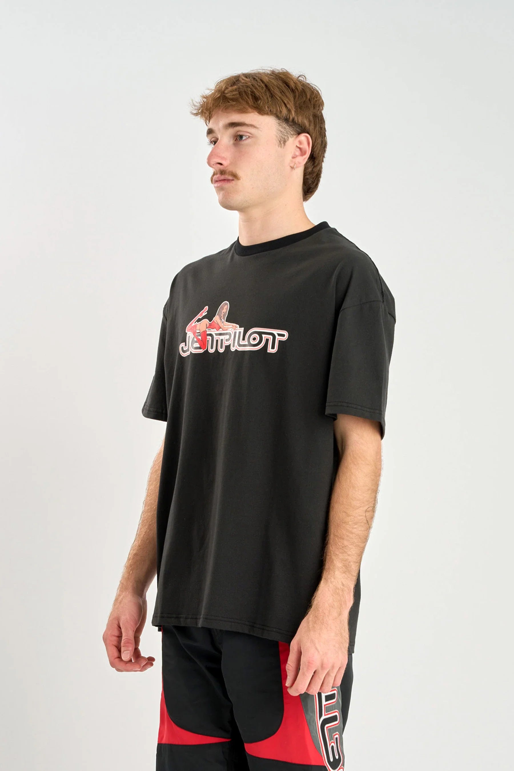 Person wearing a black t-shirt with a logo on a white background