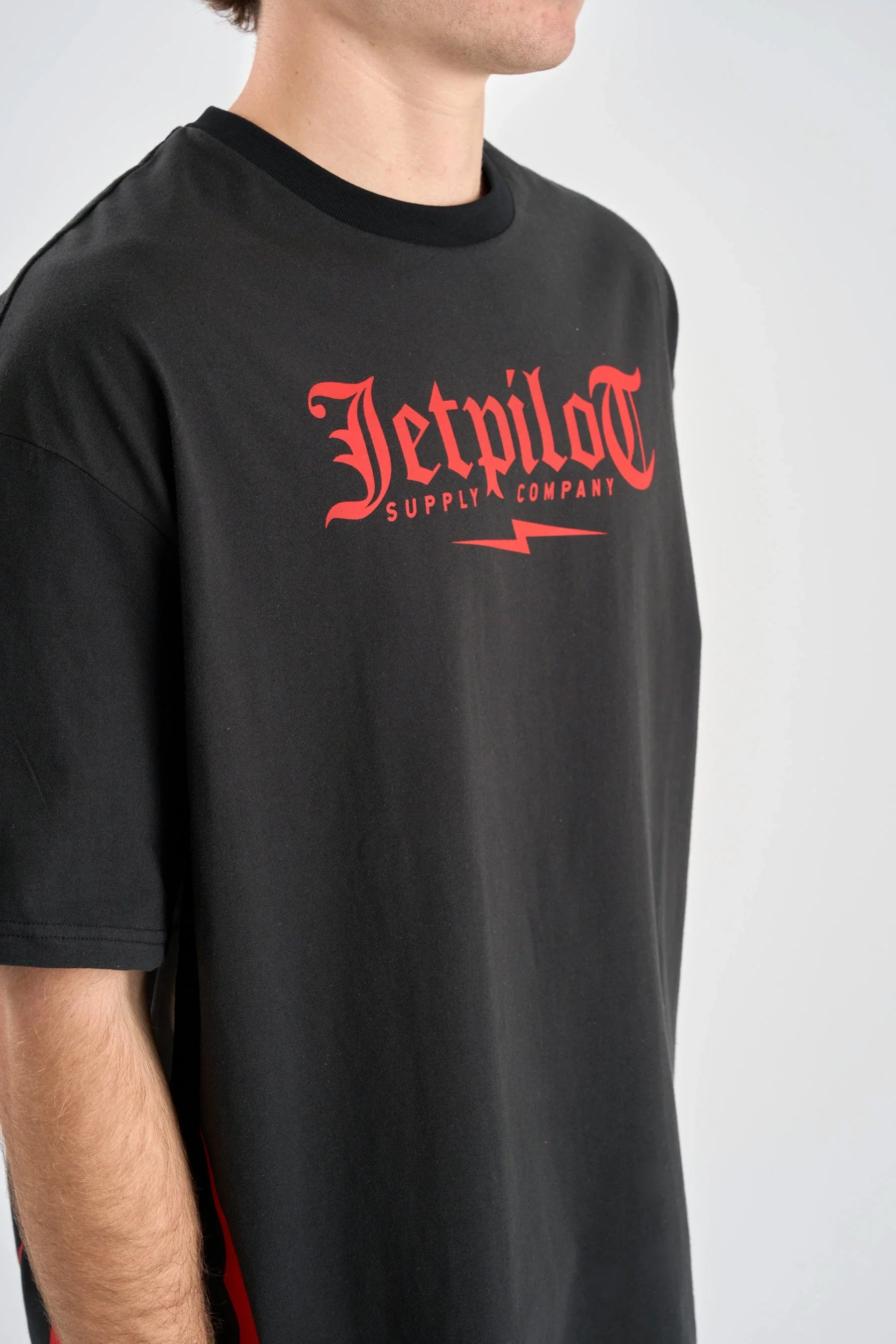 Jetpilot Tribal Heavy Tee - Black with red 'Jetpilot Supply Company' logo on a plain background