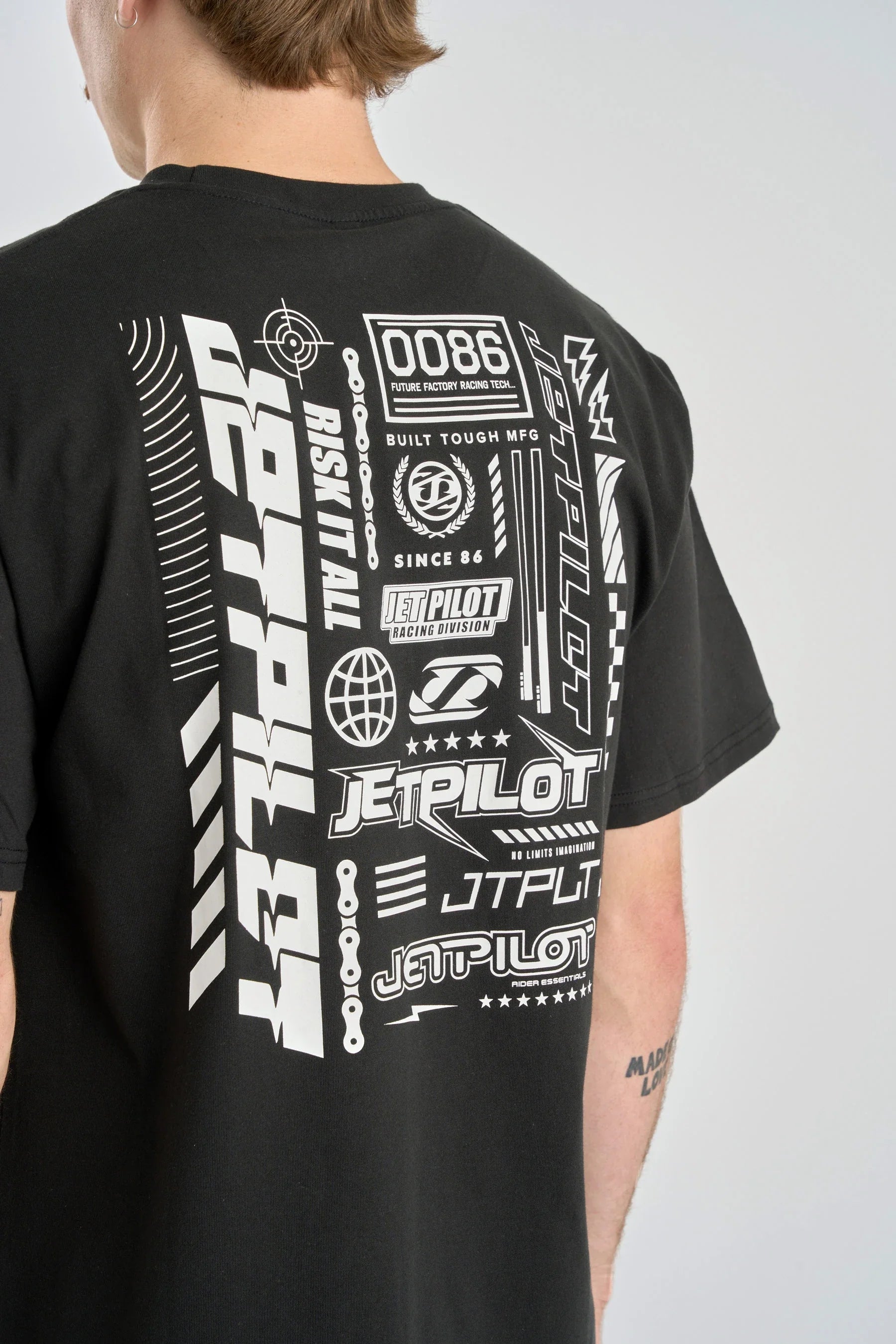 Back of Black t-shirt with white graphics and text on a gray background