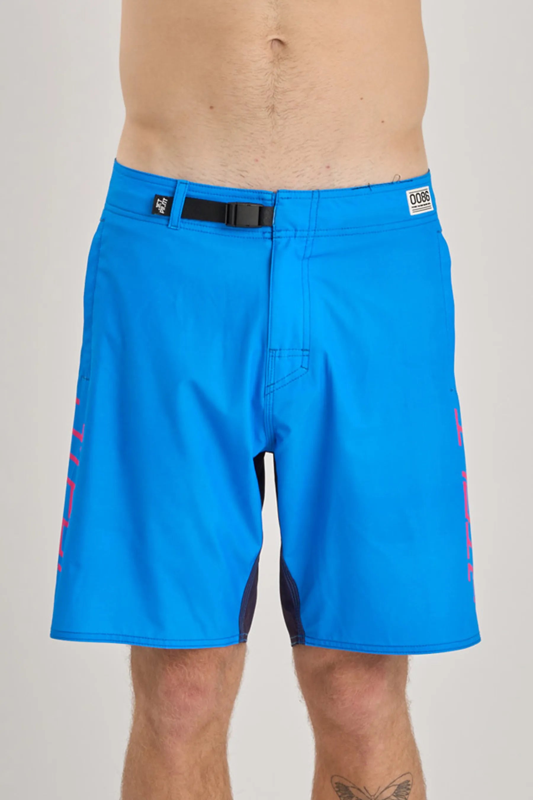 Blue board shorts with pink accents on a gray background
