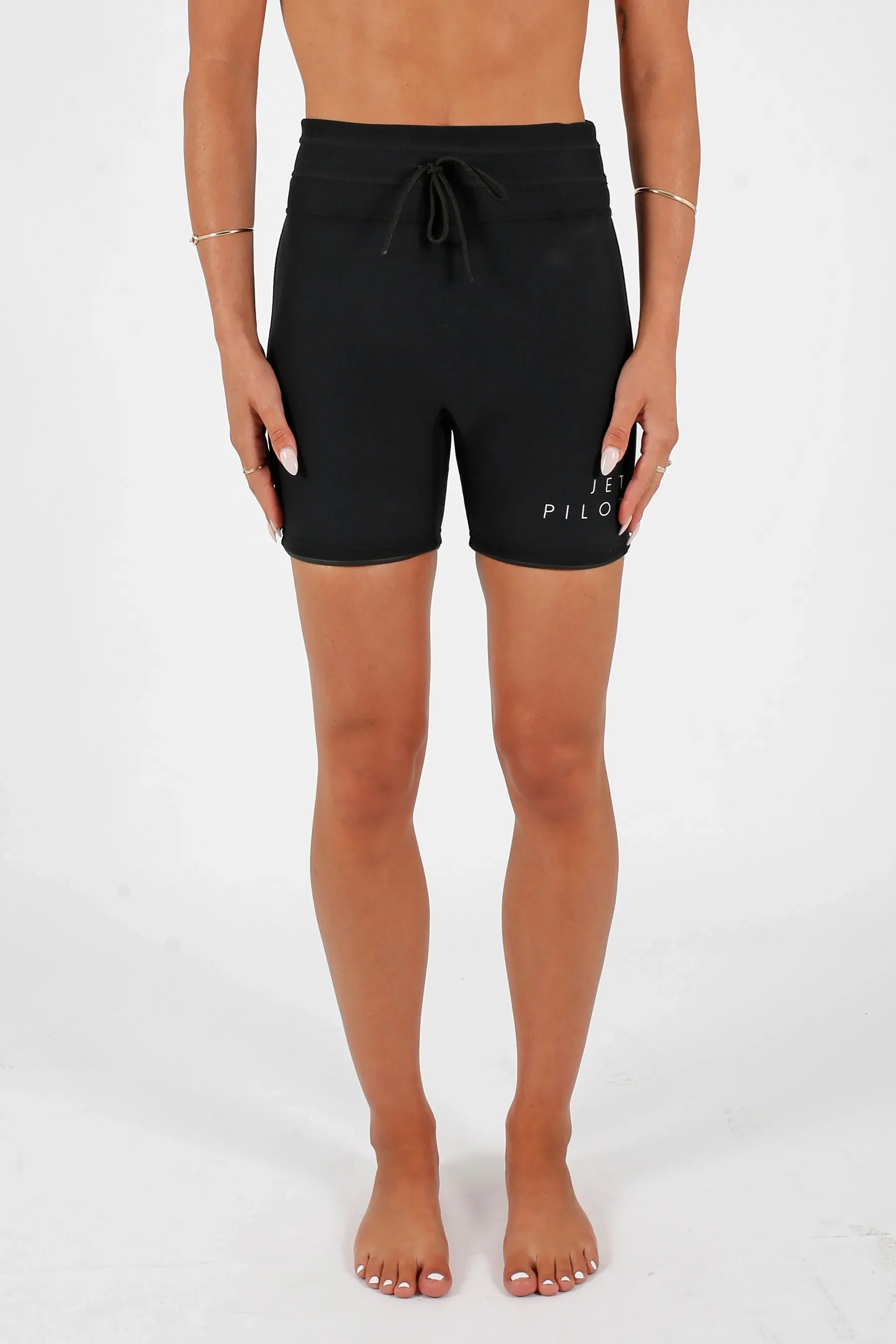 Person wearingJetpilot Corp 5" High Waisted Neoprene Short - Black on a white background